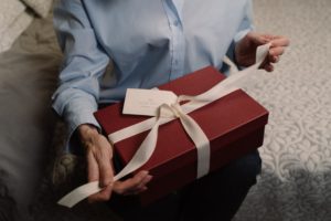 a person opening a present