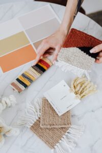 woman picking paint color and fabric from samples